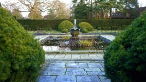 Discover serenity in a beautifully manicured garden with a central fountain, offering a peaceful retreat in the UK.