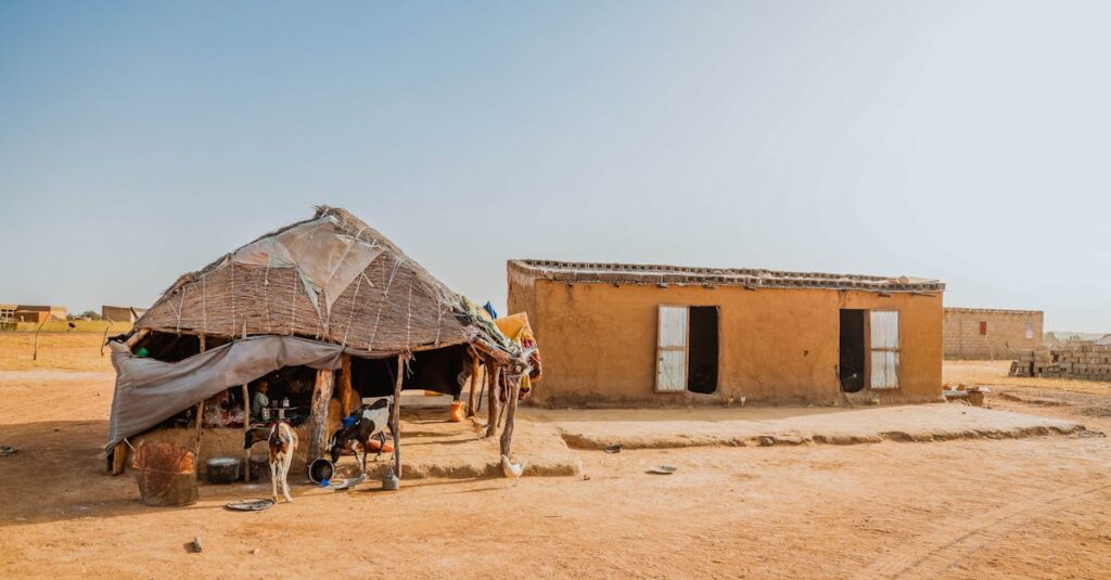 Rustic village scene in Mauritania with traditional huts and buildings.